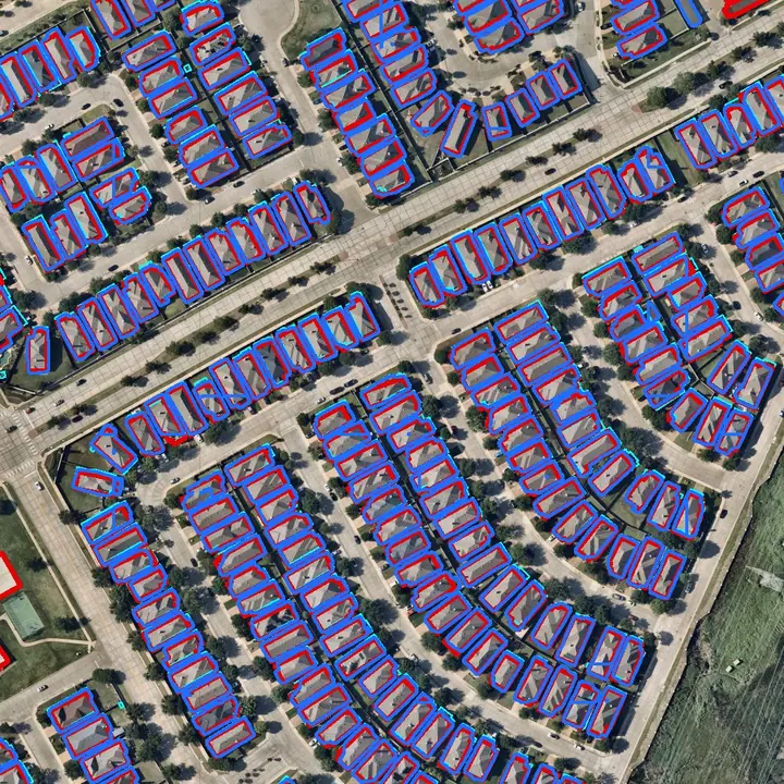 Both models outline nearly every house in a typical subdivision. Red is Esri, blue is SAM 3, thin cyan is the city’s 2015 outlines. Aerial imagery: Nearmap, May 2026.