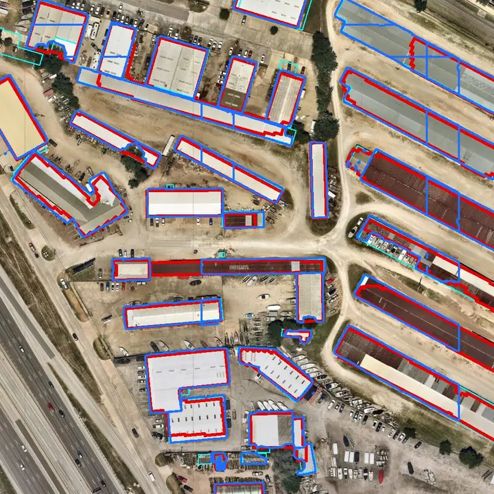 Long roofs split where SAM 3’s tiles meet; Esri’s edges step at its chip boundaries. Aerial imagery: Nearmap, May 2026.
